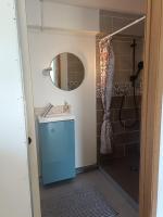 a bathroom with a shower and a sink and a mirror at 2Appartement dans un pavillon ac vue sur le jardin in Argenteuil