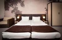 A bed or beds in a room at Rhodopi Home Hotel Chepelare - Half Board & All inclusive