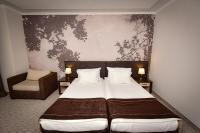 A bed or beds in a room at Rhodopi Home Hotel Chepelare - Half Board & All inclusive
