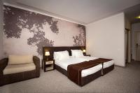 A bed or beds in a room at Rhodopi Home Hotel Chepelare - Half Board & All inclusive