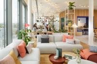 a living room with two couches and a table at Zoku Vienna in Vienna