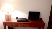 a desk with a laptop and a lamp on it at Appartement d&#39;une chambre avec terrasse amenagee a Grand Bourg in Grand-Bourg