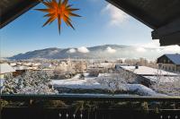 a winter view of a town with snow on the ground at Landhaus BERGSEE in Bodensdorf