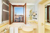 a bathroom with a sink and a window with a view at Hotel A La Commedia in Venice