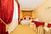 a hotel room with a bed and red curtains at Hotel A La Commedia in Venice