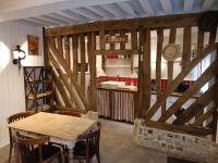 a dining room with a table and a counter at Lovely cottage in Honfleur center in Honfleur