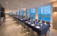 a long dining room with long tables and chairs at Grab The Ocean Songdo in Busan