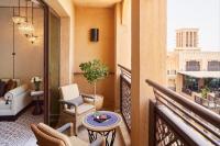 a balcony with a table and chairs on a balcony at Jumeirah Mina Al Salam Dubai in Dubai