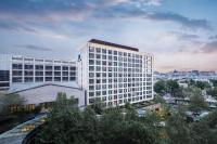 a tall white building in front of a city at Park Plaza Beijing Wangfujing in Beijing
