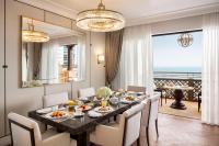 a dining room with a table with chairs and a large mirror at Jumeirah Mina Al Salam Dubai in Dubai
