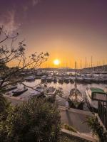 a group of boats docked in a marina at sunset at Hôtel Helios &amp; SPA - Ile des Embiez in Six-Fours-les-Plages