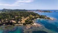 an island in the ocean with boats in the water at Hôtel Helios &amp; SPA - Ile des Embiez in Six-Fours-les-Plages