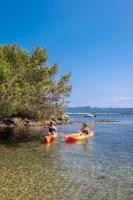 two people in kayaks in the water on a beach at Hôtel Helios &amp; SPA - Ile des Embiez in Six-Fours-les-Plages