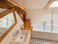 a bathroom with a bath tub and a sink at Gîte de charme avec grand jardin &amp; piscine in Touffailles