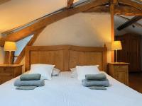 a bedroom with a large bed with two pillows on it at Gîte de charme avec grand jardin &amp; piscine in Touffailles