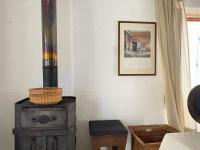 a room with a wood stove and a picture on the wall at Gîte de charme avec grand jardin &amp; piscine in Touffailles