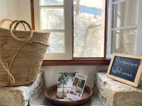 a window sill with two baskets and a sign and a book at Gîte de charme avec grand jardin &amp; piscine in Touffailles