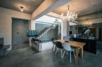 a dining room with a wooden table and chairs at 57villa in Hengchun South Gate