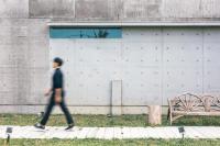 a person walking down a sidewalk near a building at 57villa in Hengchun South Gate