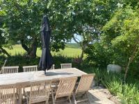 an umbrella sitting on top of a wooden table at Gîte de charme avec grand jardin &amp; piscine in Touffailles