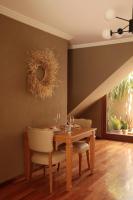 a dining room with a wooden table and chairs at Heura Petit Hotel in Ciudad Lujan de Cuyo