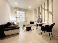 a living room with a couch and a table at Le Versant de la Cathédrale - Parking - Autonomous in Chartres