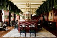a restaurant with chairs and tables and a chandelier at Slieve Donard in Newcastle