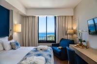 a hotel room with a bed and a desk and a window at Hôtel Helios &amp; SPA - Ile des Embiez in Six-Fours-les-Plages
