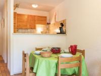 a table in a kitchen with a green table cloth at Appartement Le Monêtier-les-Bains, 2 pièces, 6 personnes - FR-1-330F-35 in Le Monêtier-les-Bains