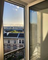a window with a view of a city at Rooms with fabulous view on Paris roofs in Paris