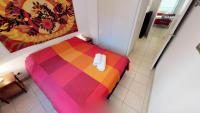 a bedroom with a colorful bed with towels on it at Résidence Royal Plaza - 3 Pièces pour 6 Personnes 084 in Menton