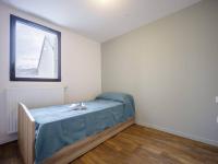 a bedroom with a bed with a blue sheet on it at Appartement Loudenvielle, 3 pièces, 6 personnes - FR-1-695-17 in Loudenvielle