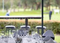 a table with wine glasses on top of it at Mercure Bunbury Sanctuary Golf Resort in Bunbury