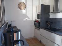 a kitchen with a sink and a clock on the wall at Gîte Arthon, 5 pièces, 8 personnes - FR-1-591-372 in Arthon