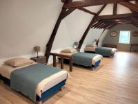 three beds in a room with wooden floors at Gîte Bazouges-sur-le-Loir, 6 pièces, 10 personnes - FR-1-410-377 in Bazouges-sur-le-Loir
