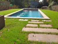 a swimming pool in the middle of a lawn at Gîte Bazouges-sur-le-Loir, 6 pièces, 10 personnes - FR-1-410-377 in Bazouges-sur-le-Loir