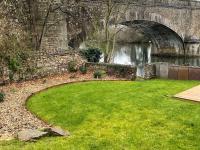 a grassy area next to a river with a bridge at Gîte Bazouges-sur-le-Loir, 6 pièces, 10 personnes - FR-1-410-377 in Bazouges-sur-le-Loir