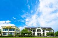 a building with a blue sky and clouds at Yun Tien Feng Chuan B&amp;B in Dongshan