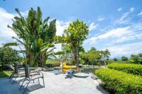 a patio with two chairs and a pond with a yellow raft at Yun Tien Feng Chuan B&amp;B in Dongshan