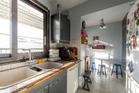 a kitchen with a sink and a window at 120 Grenelle - Spacieux Duplex avec vue sur la tour Eiffel in Paris