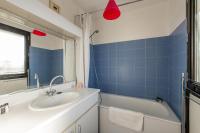a bathroom with a sink and a tub and a mirror at 120 Grenelle - Spacieux Duplex avec vue sur la tour Eiffel in Paris