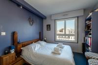 a bedroom with a bed and a window at 120 Grenelle - Spacieux Duplex avec vue sur la tour Eiffel in Paris