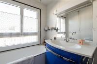 a bathroom with a sink and a large window at 120 Grenelle - Spacieux Duplex avec vue sur la tour Eiffel in Paris