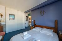 a bedroom with a large bed with towels on it at 120 Grenelle - Spacieux Duplex avec vue sur la tour Eiffel in Paris