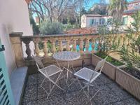 a table and two chairs on a balcony at Best Western L&#39;Orangerie in Nîmes