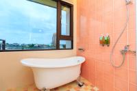 a bath tub in a bathroom with a window at Elegance House in Wujie