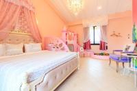 a pink bedroom with a bed and a princess room at Elegance House in Wujie