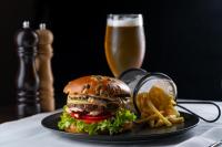 a hamburger and french fries and a glass of beer at Europa Royale Bucharest in Bucharest