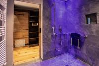 a purple bathroom with a walk in shower at Hundehotel Riederhof in Ried im Oberinntal