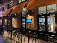 a happy hour restaurant with benches in front of it at Residence Inn by Marriott San Diego Downtown/Gaslamp Quarter in San Diego